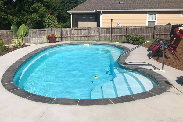 oyster fiberglass swimming pool next to house