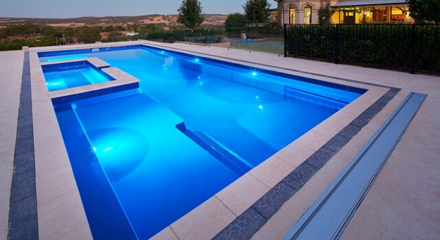 Sydney Harbour fiberglass pool model illuminated at night by Barrier Reef Pools LLC