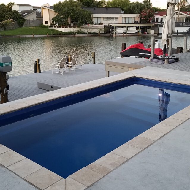 Escape Plunge in Ocean Shimmer — compact fiberglass plunge pool featuring a vibrant blue finish for small backyard spaces.