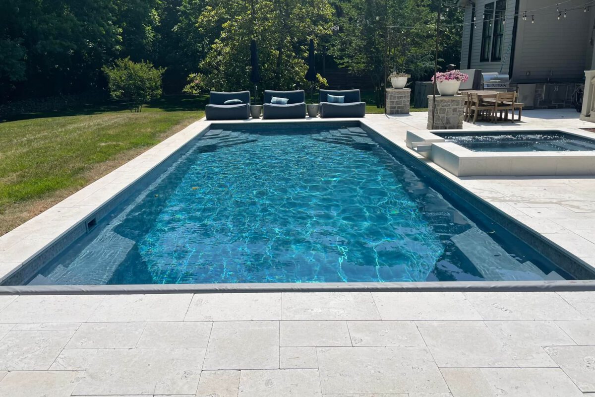 Whitsunday fiberglass pool in Evening Sky color — elegant inground pool with rich blue shimmer by Barrier Reef Pools.