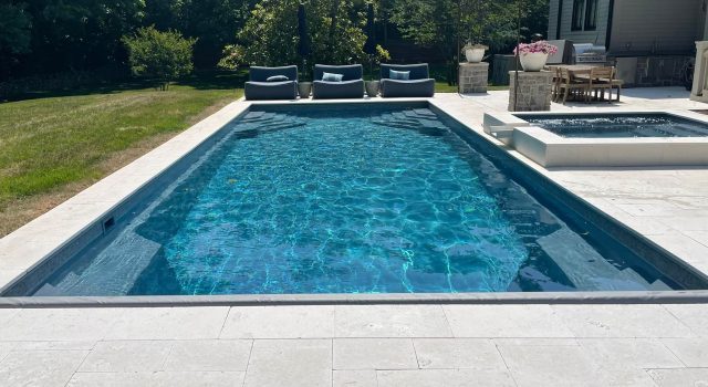 Whitsunday fiberglass pool in Evening Sky color — elegant inground pool with rich blue shimmer by Barrier Reef Pools.